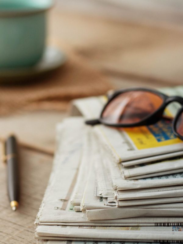 Newspapers and glasses on wooden floors.